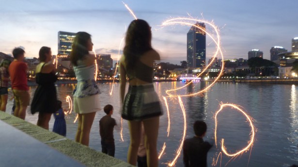 Students writing "Marry me" into the air
